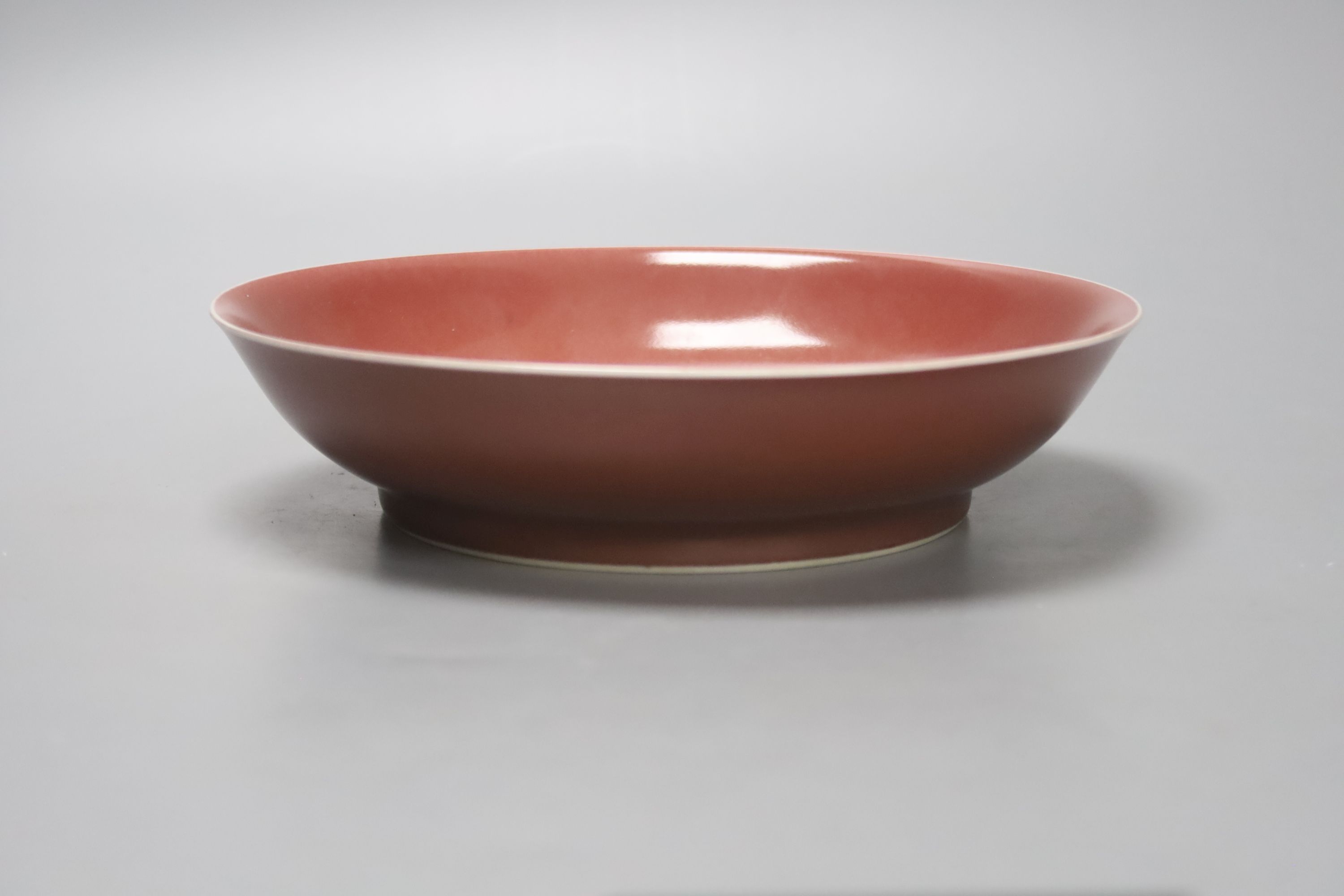 A Chinese Sang de Boeuf footed bowl, Qianlong seal mark to underside, 21cm diameter 5cm high